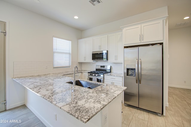 2228 E Isaiah Ave, Gilbert, AZ 85298 - kitchen featuring stainless steel appliances, a sink, white cabinets, backsplash, and a peninsula