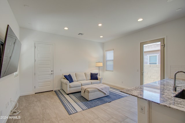 living room featuring a healthy amount of sunlight and sink