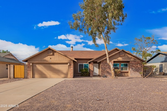 ranch-style home featuring concrete driveway, an attached garage, fence, and brick siding