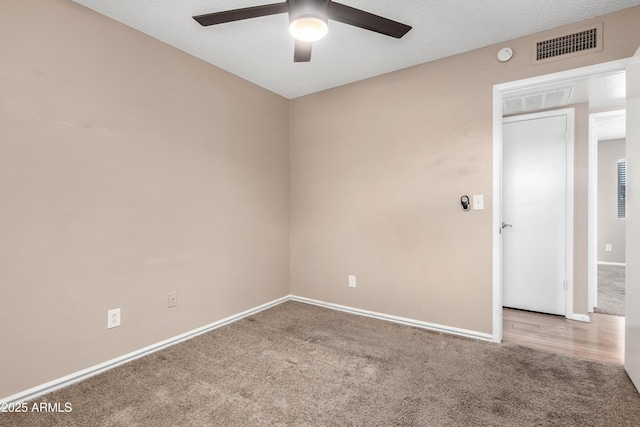 spare room featuring a ceiling fan, baseboards, visible vents, a textured ceiling, and carpet flooring