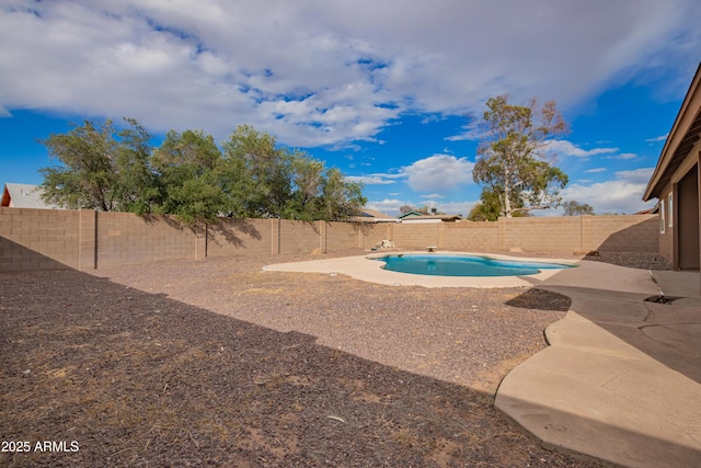 view of swimming pool featuring a patio area, a fenced in pool, and a fenced backyard