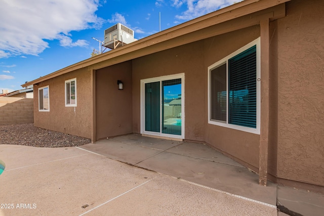 back of house with a patio, central AC unit, fence, and stucco siding