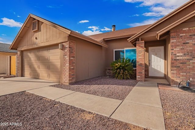 view of front of house with a garage, brick siding, and concrete driveway