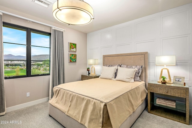 bedroom featuring a mountain view and light colored carpet