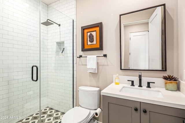 bathroom with toilet, vanity, and walk in shower