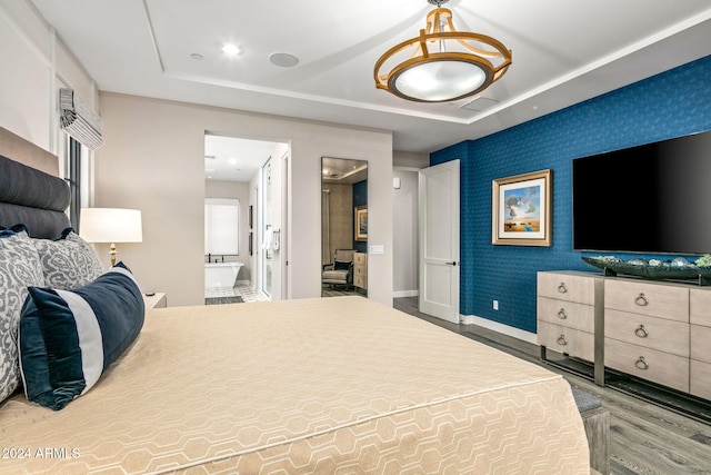 bedroom featuring wood-type flooring and connected bathroom