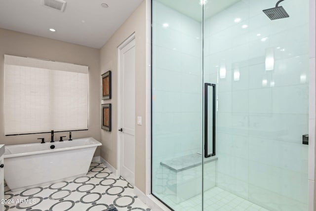 bathroom with shower with separate bathtub