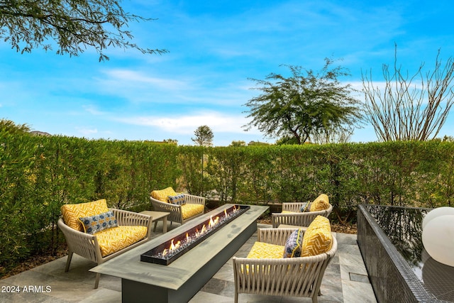 view of patio featuring an outdoor living space with a fire pit