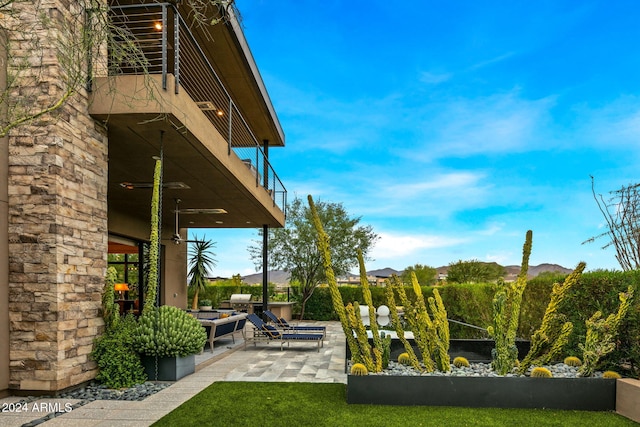 view of yard featuring a balcony and a patio