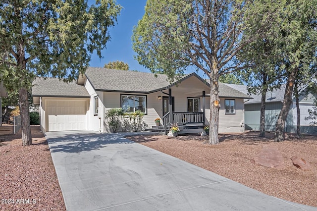 single story home with covered porch and a garage