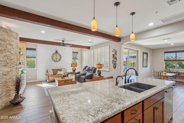30342 N 130th Dr, Peoria, AZ 85383 - kitchen featuring a sink, beam ceiling, an island with sink, visible vents, and light stone countertops