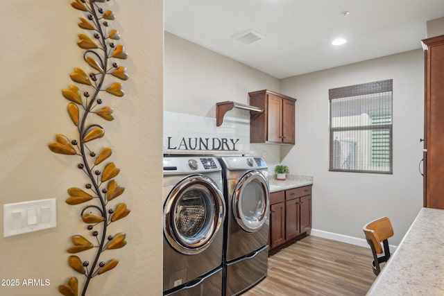 30342 N 130th Dr, Peoria, AZ 85383 - laundry room with baseboards, separate washer and dryer, visible vents, light wood-style flooring, and cabinet space