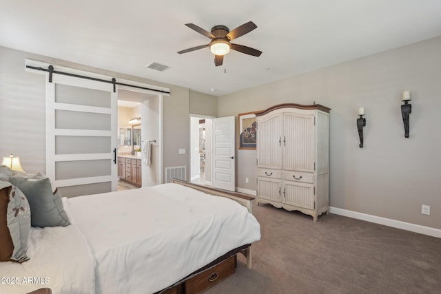 30342 N 130th Dr, Peoria, AZ 85383 - carpeted bedroom with baseboards, a barn door, connected bathroom, and visible vents