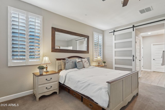 30342 N 130th Dr, Peoria, AZ 85383 - carpeted bedroom featuring baseboards, a barn door, and visible vents