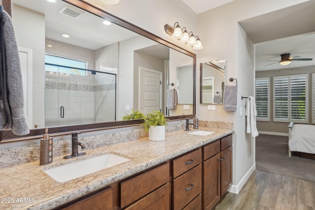 30342 N 130th Dr, Peoria, AZ 85383 - full bath with visible vents, a sink, a stall shower, and wood finished floors