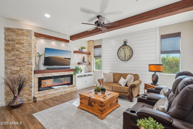 30342 N 130th Dr, Peoria, AZ 85383 - living room featuring beam ceiling, wood finished floors, a glass covered fireplace, ceiling fan, and recessed lighting