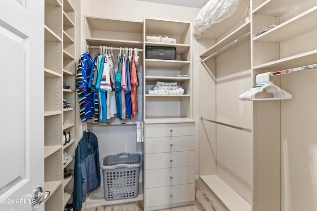 walk in closet featuring light hardwood / wood-style flooring