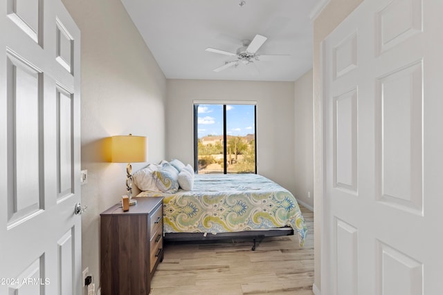 bedroom with light hardwood / wood-style flooring and ceiling fan