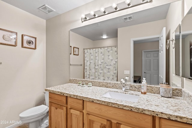 bathroom with vanity, toilet, and a shower with curtain