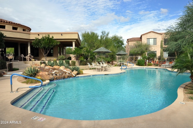 view of swimming pool with a patio