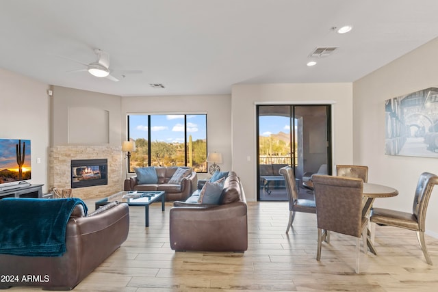 living room with light hardwood / wood-style flooring and ceiling fan