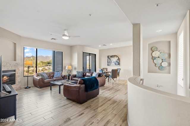 living room featuring ceiling fan and light hardwood / wood-style flooring