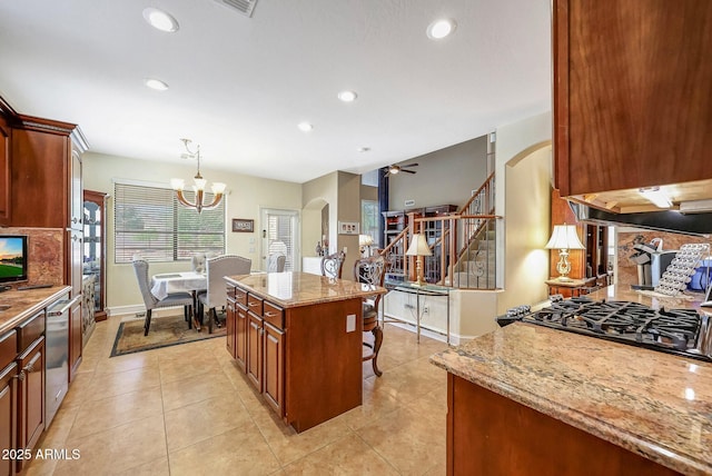 2726 S 160th Ave, Goodyear, AZ 85338 - kitchen featuring arched walkways, light stone countertops, recessed lighting, a chandelier, and light tile patterned floors