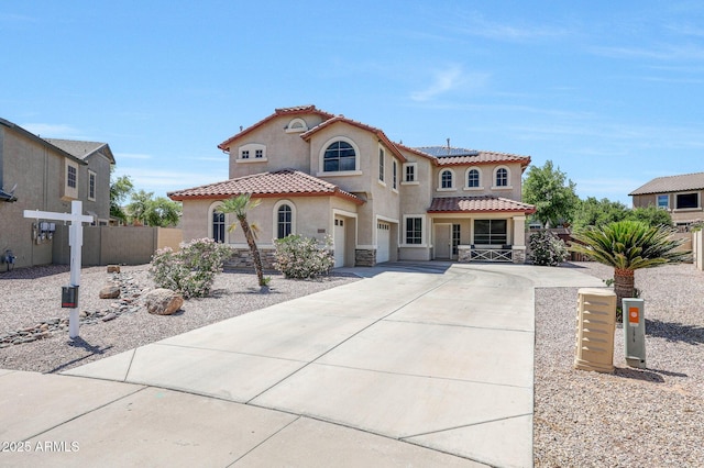 2726 S 160th Ave, Goodyear, AZ 85338 - mediterranean / spanish-style house featuring driveway, stucco siding, a tile roof, solar panels, and fence