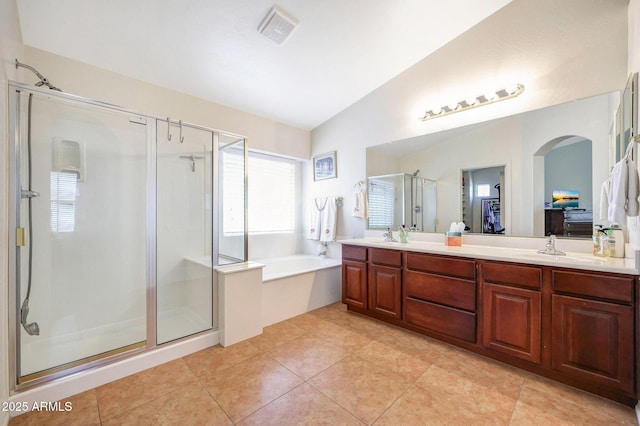 2726 S 160th Ave, Goodyear, AZ 85338 - full bathroom featuring a shower stall, a garden tub, double vanity, lofted ceiling, and tile patterned flooring