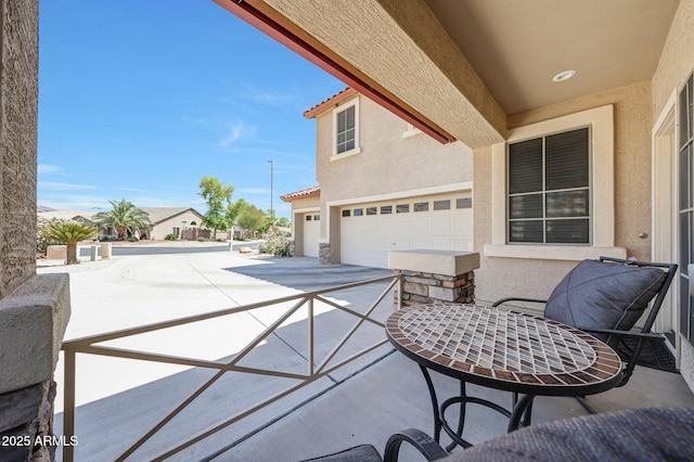 2726 S 160th Ave, Goodyear, AZ 85338 - view of patio featuring a garage and concrete driveway