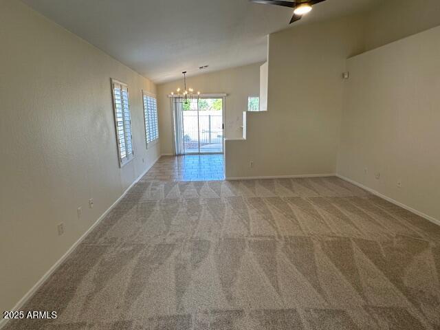 20275 N 81st Ln, Peoria, AZ 85382 - carpeted empty room with a chandelier, vaulted ceiling, baseboards, and ceiling fan