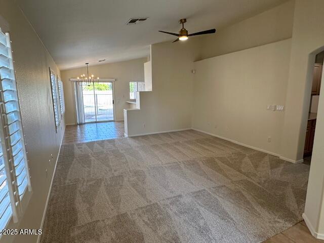20275 N 81st Ln, Peoria, AZ 85382 - carpeted empty room featuring vaulted ceiling, a chandelier, a ceiling fan, baseboards, and arched walkways