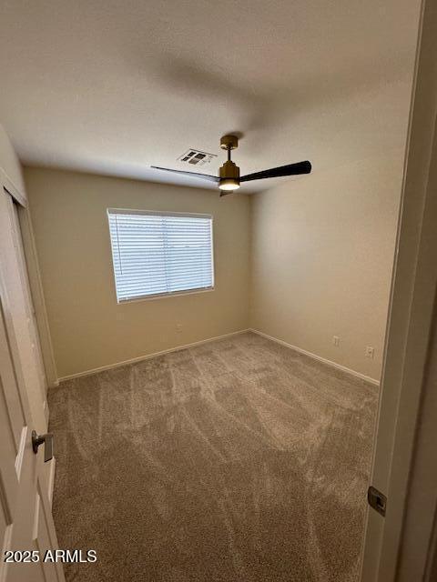 20275 N 81st Ln, Peoria, AZ 85382 - unfurnished bedroom with carpet, baseboards, ceiling fan, and a closet