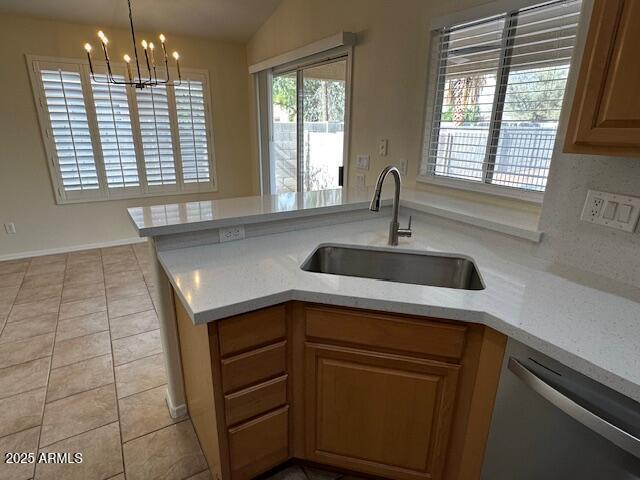 20275 N 81st Ln, Peoria, AZ 85382 - kitchen featuring stainless steel dishwasher, a sink, a peninsula, a chandelier, and light tile patterned flooring