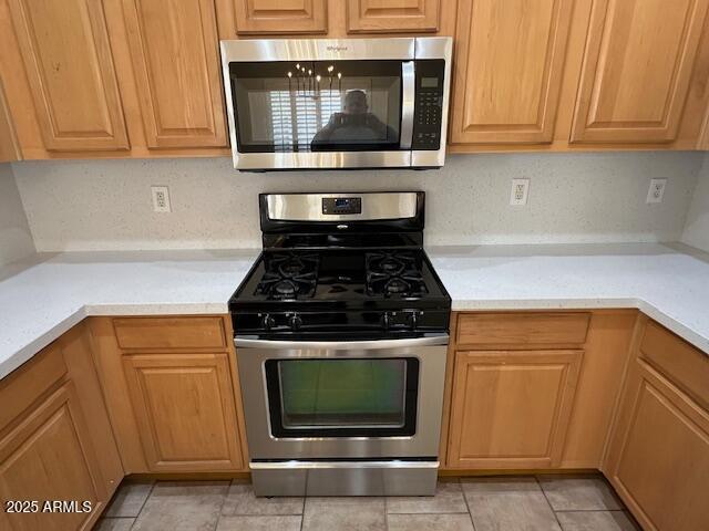 20275 N 81st Ln, Peoria, AZ 85382 - kitchen featuring appliances with stainless steel finishes, light countertops, and light tile patterned floors