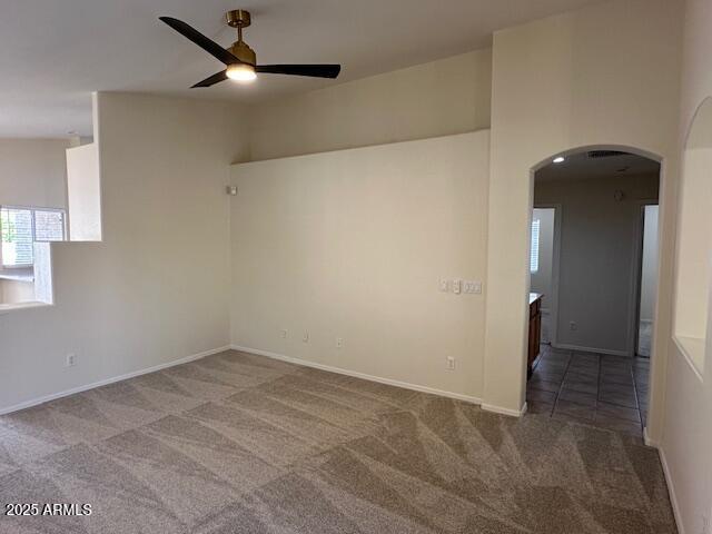 20275 N 81st Ln, Peoria, AZ 85382 - carpeted empty room featuring a ceiling fan, arched walkways, and baseboards