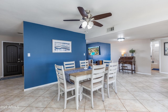 tiled dining area featuring ceiling fan