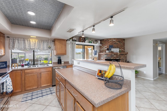 kitchen with dishwasher, a center island, sink, and a brick fireplace