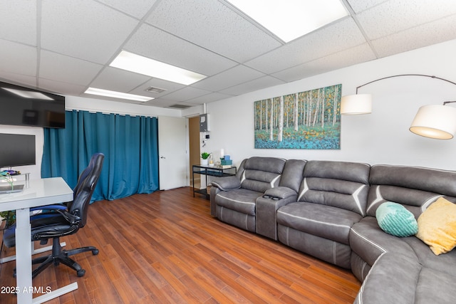 office area featuring a paneled ceiling and hardwood / wood-style floors