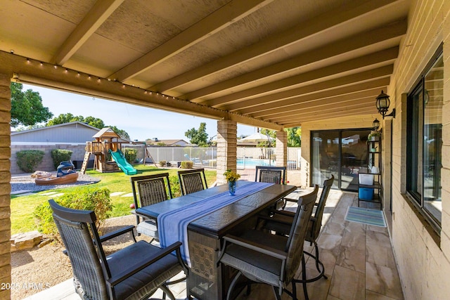 view of patio / terrace with a swimming pool and a playground