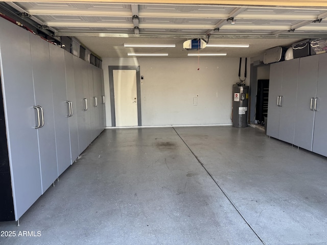 garage featuring a garage door opener and electric water heater