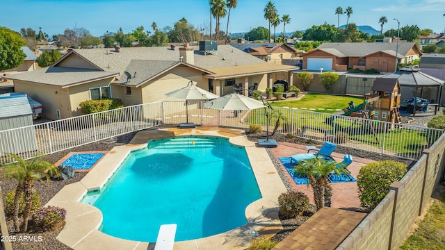 view of swimming pool with a playground and central air condition unit