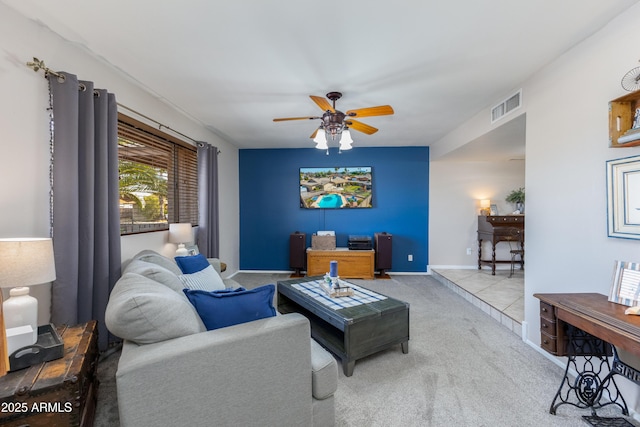 carpeted living room with ceiling fan