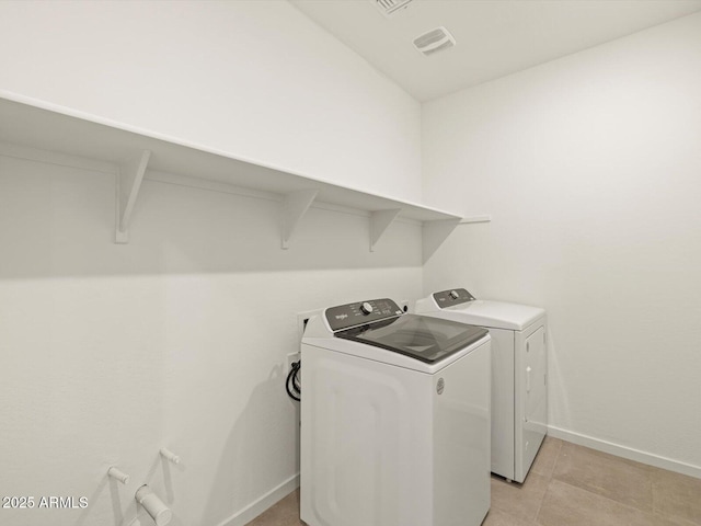 washroom featuring washer and dryer and light tile patterned floors