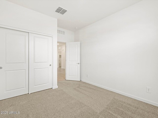 unfurnished bedroom with carpet and a closet