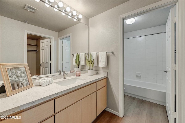 29606 N Tatum Blvd N Unit 265, Cave Creek, AZ 85331 - full bath featuring vanity, wood finished floors, tub / shower combination, and a textured wall