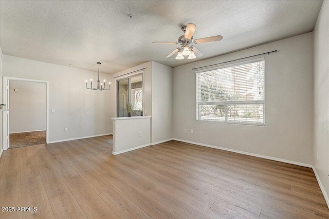 29606 N Tatum Blvd N Unit 265, Cave Creek, AZ 85331 - unfurnished room with a chandelier, light wood-type flooring, ceiling fan, and a textured ceiling