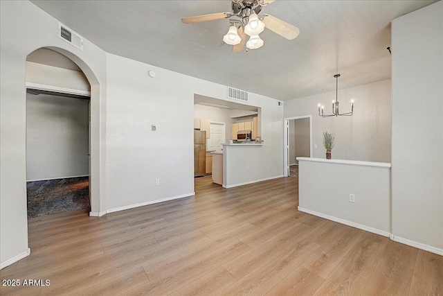 29606 N Tatum Blvd N Unit 265, Cave Creek, AZ 85331 - unfurnished living room with a chandelier, light wood finished floors, ceiling fan, and arched walkways
