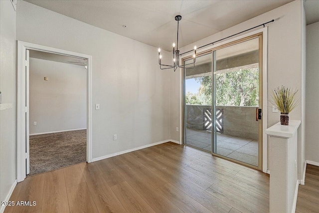29606 N Tatum Blvd N Unit 265, Cave Creek, AZ 85331 - unfurnished dining area featuring wood finished floors and a chandelier