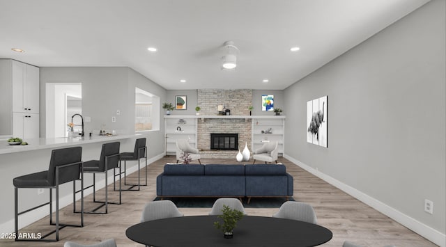 living area with recessed lighting, light wood-style floors, and plenty of natural light